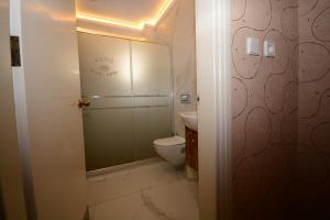 a bathroom with a toilet and a sink at deniz apart hotel in Kuşadası +31 photos