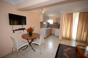 a kitchen and dining room with a table and chairs at deniz apart hotel in Kuşadası