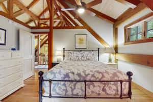 a bedroom with a bed and a wooden ceiling at Splendor On The Lake in Center Harbor