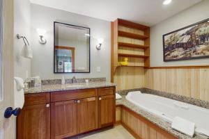 a bathroom with a bath tub and a sink at Splendor On The Lake in Center Harbor +18 photos