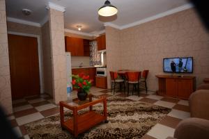 a living room with a table and a kitchen at deniz apart hotel in Kuşadası