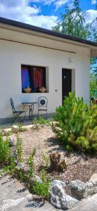 a patio with a table and chairs in front of a house at B&B La Foglietta in Paganica