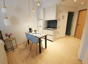 a kitchen and living room with a table and chairs at SEAL of Deer - Castle View - 5 minute walk to the Beach in Rhodes Town