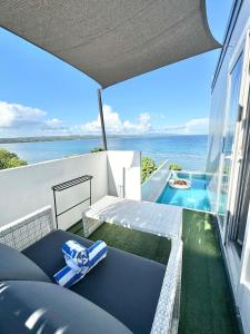 a balcony with a bench and a view of the ocean at Epic Suites Bohol ADULTS ONLY in Dauis