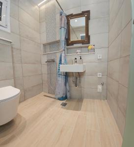 a bathroom with a sink and a toilet at SEAL of Knight - Castle View - Downtown near the Beach in Rhodes Town +5 photos