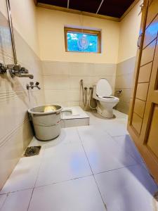 a bathroom with a toilet and a window at Riverfront resort sooq valley in Dargai