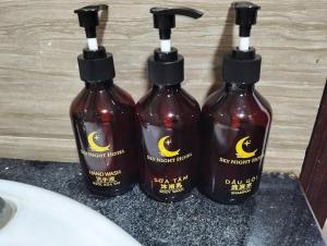 a group of three shampoo bottles sitting on top of a sink at Sky Night Hotel in Bồ Sơn