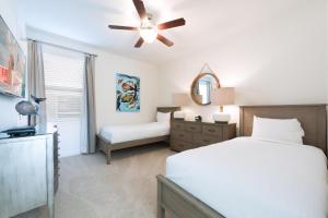 a bedroom with a bed and a ceiling fan at Luxury Home Near Disney With Private Pool, Waterpark & Resort Access At Encore Resorts Reunion - 211Mn in Kissimmee