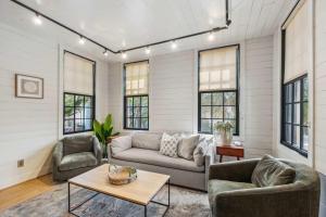 a living room with a couch and chairs and windows at Revitalized Historical Southern Residence in Charleston