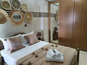 a bedroom with a large bed with towels on it at Surf appartement Taghazout 4 in Taghazout