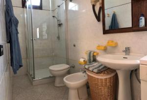 a bathroom with a shower and a toilet and a sink at I Trulli di Mimì in Monopoli +10 photos