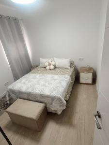 a bedroom with a bed with a teddy bear on it at Apartamento patio Andaluz in Rota