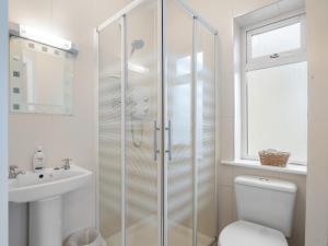 a bathroom with a shower and a toilet and a sink at Cuirt Haven Clifden in Clifden +19 photos