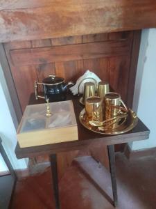 a table with a tray with a tea set on it at Galagoda Mansion in Matale
