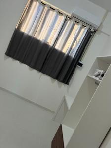 a window in a room with a black curtain at Orla Flats - Apartamento 04 in Bragança +2 photos