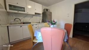 a kitchen with a table with a vase of flowers on it at Downtown Dream Makarska in Makarska +27 photos