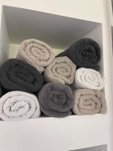 a white box filled with gray and white towels at Florida Gulf Coast Luxury Oasis in St Petersburg +56 photos