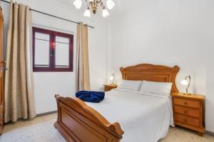a bedroom with a large bed and a window at Casa Abuela Maruca in Corralejo