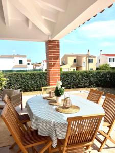a patio with a table and chairs on a patio at Villa Aire in Cala en Blanes