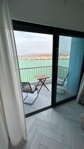 a view of a balcony with a table and chairs at Ayla Aqaba Azure 2 bedroom 0922 in Aqaba