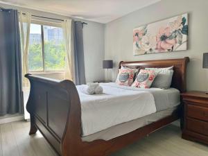 a bedroom with a bed with a teddy bear on it at Heart Downtown 2BD NEW Paint floor CITY View LM207 in Atlanta