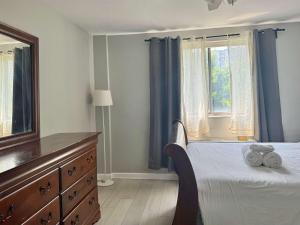 a bedroom with a bed and a dresser and a window at Heart Downtown 2BD NEW Paint floor CITY View LM207 in Atlanta
