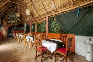 a dining room with tables and chairs in a building at Dream jet suites in Entebbe