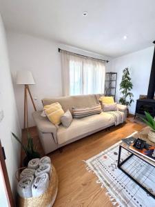 a living room with a couch and a table at Villa Aire in Cala en Blanes