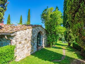 an old stone building in a garden with trees at Holiday Home Il Fienile by Interhome in Scandicci