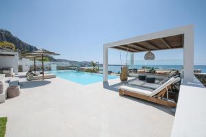 an outdoor patio with a view of the ocean at Elements Villas in Lartos