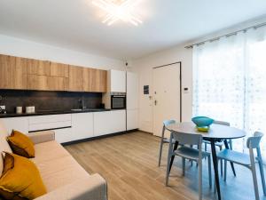 a living room with a couch and a table at Holiday Home Suite Garden 31 by Interhome in Villanova dʼAlbenga