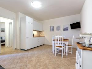 a kitchen and dining room with a table and chairs at Apartment Sa Minda by Interhome in Valledoria +24 photos