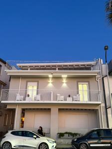 a white car parked in front of a house at Affaccio sul Mare in Capo dʼOrlando