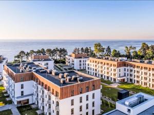an aerial view of buildings with the ocean in the background at Apartment Gąski by Interhome in Gąski