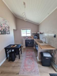 a kitchen with a table and a sink and a counter at LieBling Place in Cape Town +7 photos