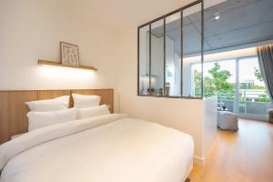 Postel nebo postele na pokoji v ubytování Babel Community Hôtel Lille - Villeneuve d'Ascq + 37 fotografií