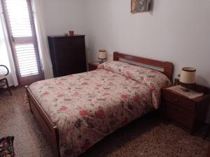 a bedroom with a bed and a dresser and two lamps at Casa Numari in Caudiel