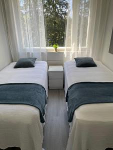 Ένα ή περισσότερα κρεβάτια σε δωμάτιο στο Beach House Yyteri