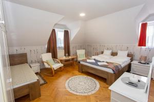 a bedroom with two beds and a table and chairs at Dio Apartmanok in Balatonboglár +177 photos
