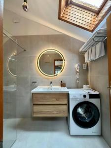 a bathroom with a washing machine and a sink at Apartments Kalina in Jelsa