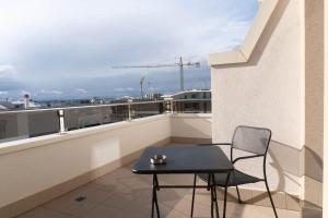 a table and chair on a balcony with a view at Elementi B&B in Altamura