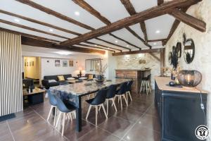 a kitchen and living room with a large table and chairs at Le gîte du besson in Cassagne