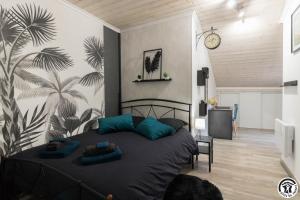 a bedroom with a bed with blue pillows on it at Le gîte du besson in Cassagne +45 photos
