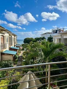 a view from a balcony of houses and the ocean at Sea view Ginger apartment in Pointe aux Biches