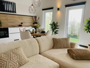 a living room with a couch and a table at Ô Cinquante - Gite Wellness, Marchin in Marchin