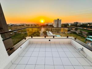 a balcony with the sunset in the background at Gangaur Residency in Jodhpur