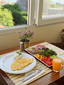 a breakfast table with a omelet and a plate of food at BACHOS HOTEL SULTANAHMET sea view terrace in Istanbul