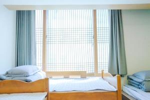 Postel nebo postele na pokoji v ubytování Cocoa Guesthouse