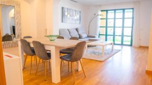 a dining room table and chairs in a living room at Villa Luisa - Relax with Ocean View and Pool in San Miguel de Abona