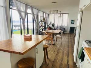 a kitchen and dining room with a table and a dining table at Nogal in San Carlos de Bariloche